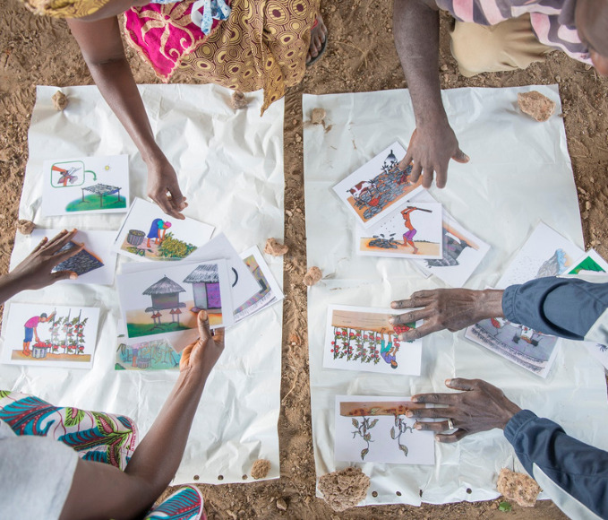 hands moving pieces of paper during brainstorm
