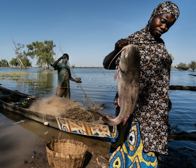 woman holding a fish recently fished
