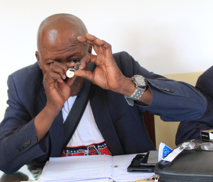 man inspecting diamond