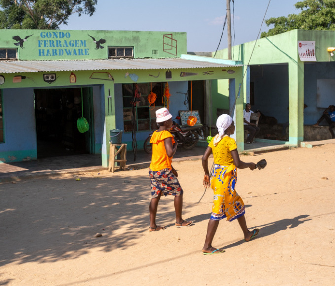 Women walking through a village in Mozambique.