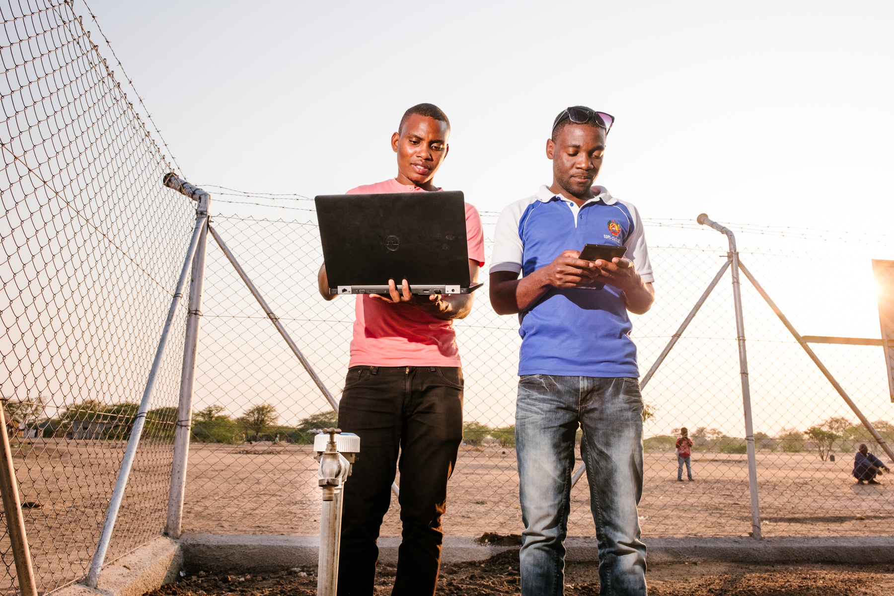 two men registering a water supply system on the database