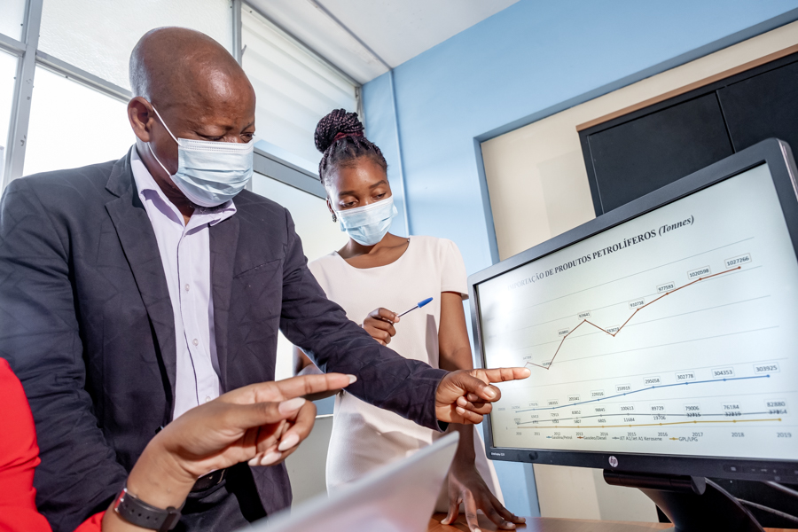 man explaining a graphic on a computer