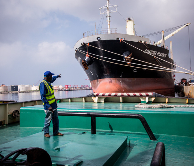 man pointing at a boat at the port