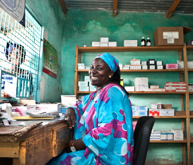 Medical workers sitting behind the medicine dispensary desk.