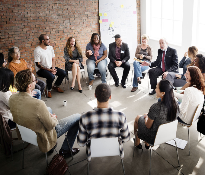 young people sit in a circle and discuss education challenges.