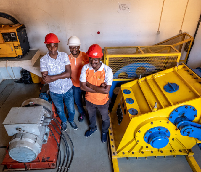workers of the small hydro power plant in Sembezeia Mozambique pose for a picture inside the plant.